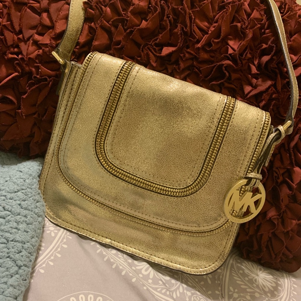 Gold Michael Kors crossbody purse.